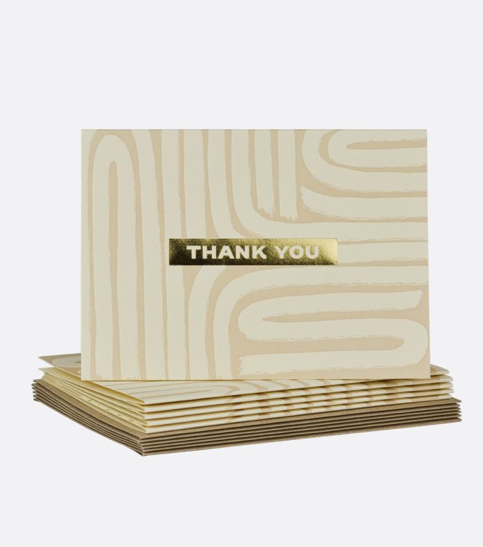 stack of textured lines letterpress boxed notes with one standing on top, card features a brushed line design with thank you written in gold foil